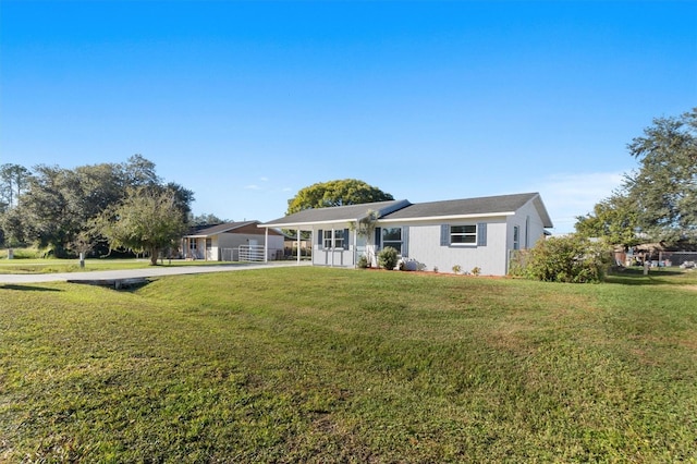 ranch-style home featuring a carport and a front yard