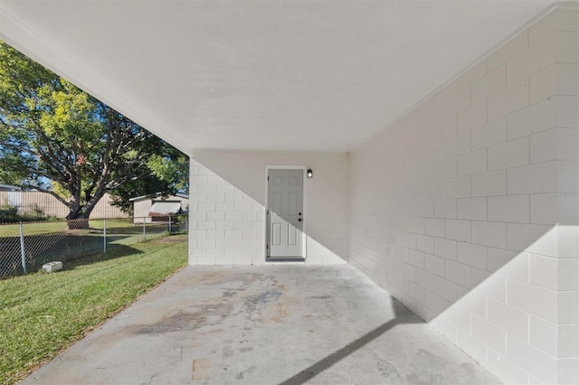 entrance to property featuring a patio area and a yard