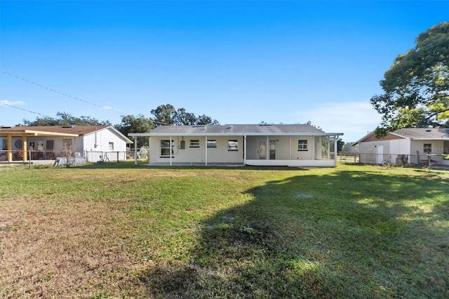 rear view of property with a lawn