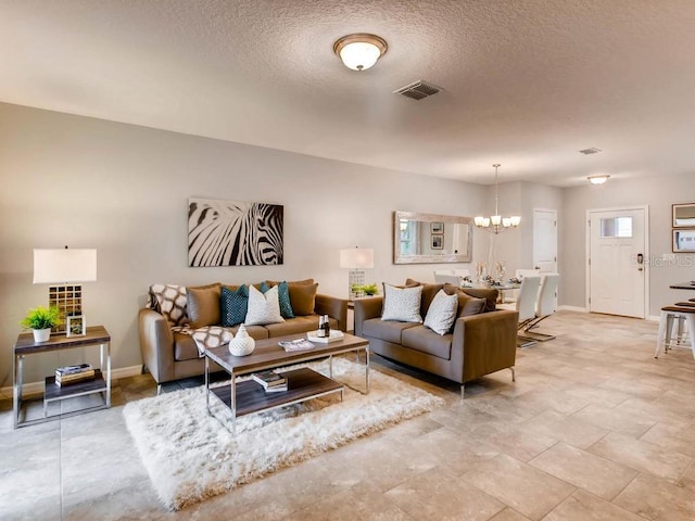 living room with a textured ceiling and an inviting chandelier