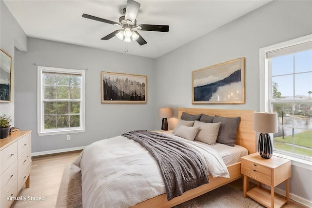 bedroom with ceiling fan and light wood-type flooring