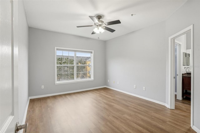 empty room featuring hardwood / wood-style flooring and ceiling fan