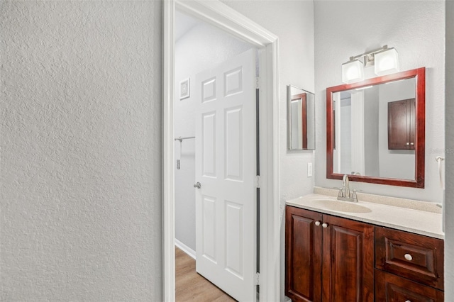 bathroom featuring hardwood / wood-style floors and vanity