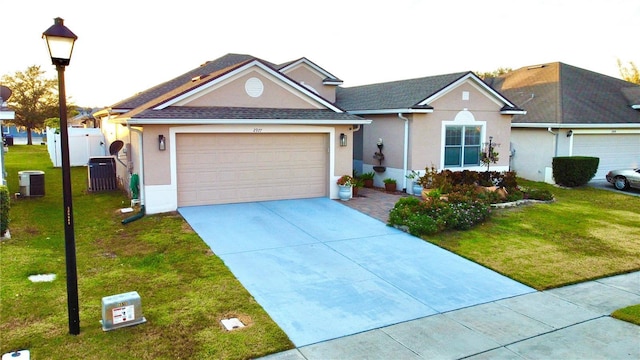 view of front facade with central air condition unit, a front lawn, and a garage