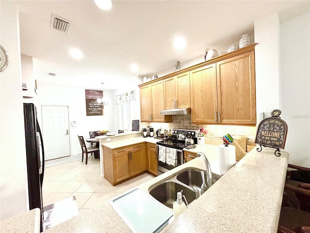 kitchen with black refrigerator, electric stove, sink, hanging light fixtures, and kitchen peninsula