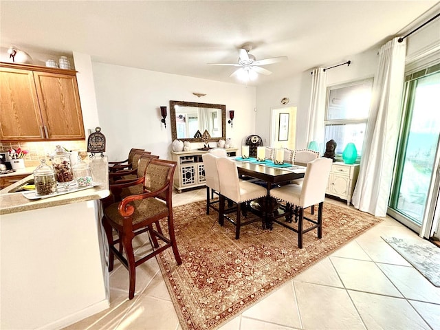 tiled dining room with ceiling fan