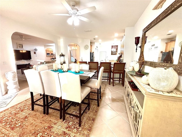 tiled dining area featuring a textured ceiling and ceiling fan