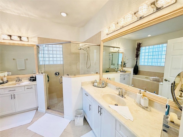 bathroom featuring tile patterned flooring, vanity, and a shower with shower door