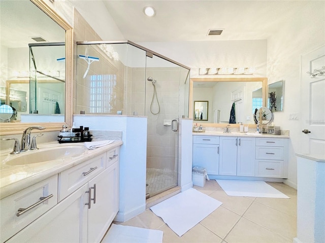 bathroom featuring tile patterned floors, vanity, and walk in shower