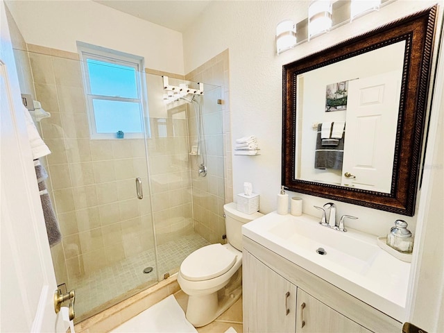 bathroom with tile patterned floors, vanity, toilet, and a shower with shower door