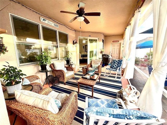 exterior space featuring a textured ceiling and ceiling fan