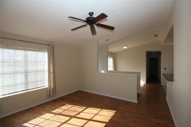 spare room with ceiling fan, dark wood-type flooring, and lofted ceiling