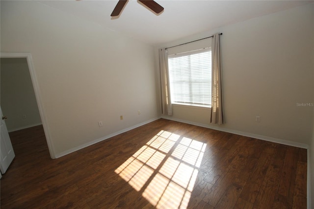 spare room featuring ceiling fan and dark hardwood / wood-style flooring