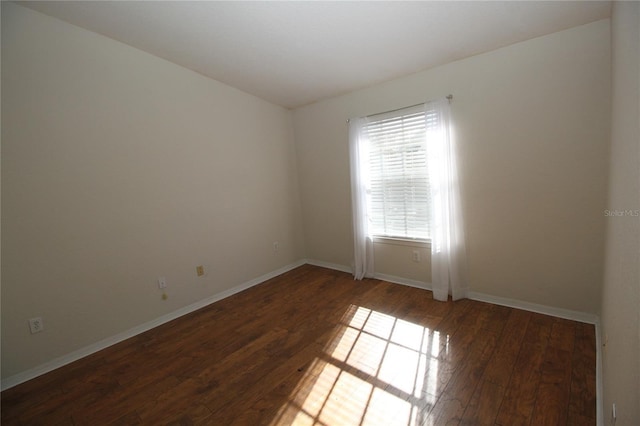 empty room with dark wood-type flooring