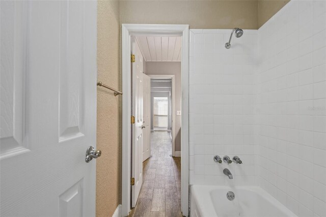 bathroom featuring hardwood / wood-style flooring and shower / bath combination