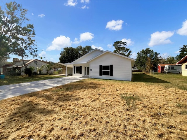 ranch-style home featuring a front yard and a carport