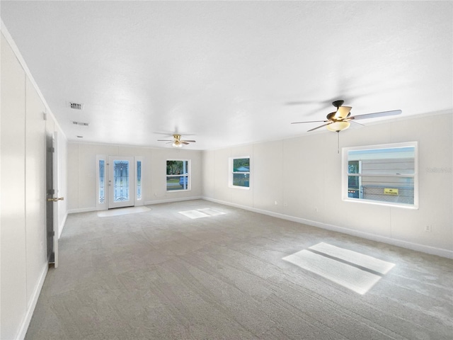 carpeted empty room featuring ceiling fan and crown molding