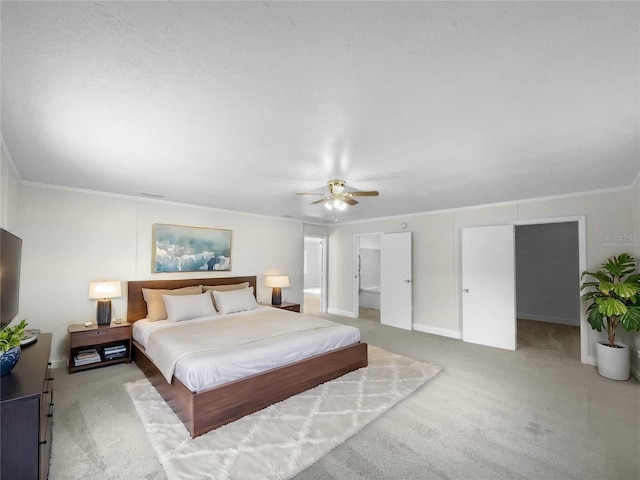 carpeted bedroom with a textured ceiling, ceiling fan, and crown molding