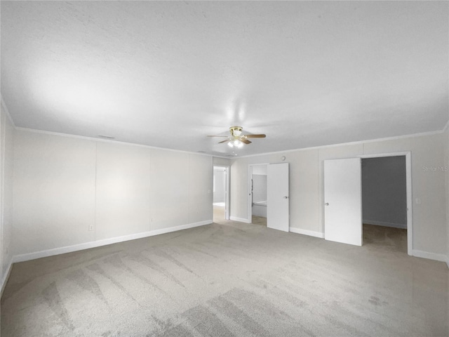 interior space featuring carpet flooring, ceiling fan, and ornamental molding