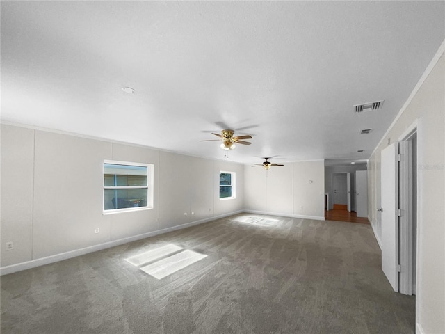 unfurnished living room with ceiling fan and carpet