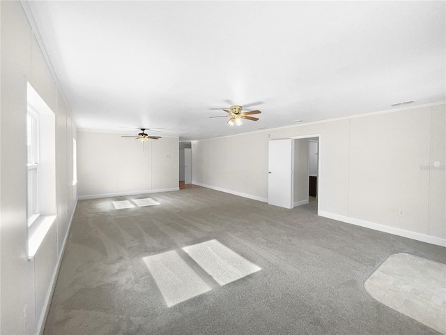 spare room with ceiling fan, carpet floors, and crown molding