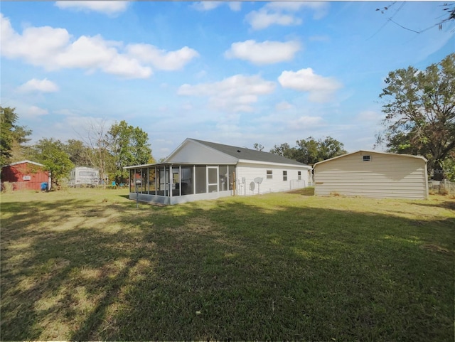 back of property with a sunroom and a yard