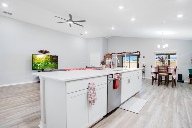 kitchen featuring sink, stainless steel dishwasher, an island with sink, lofted ceiling, and white cabinets