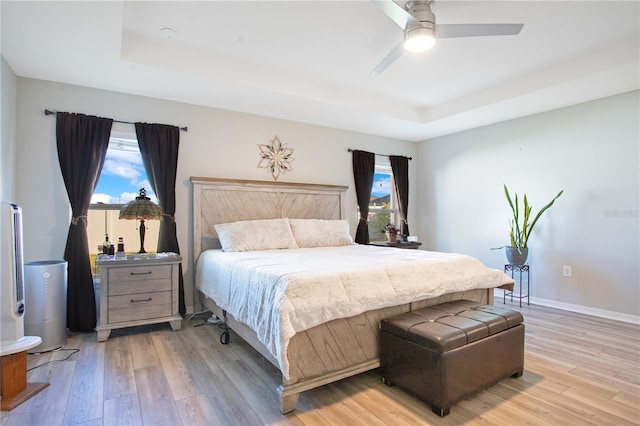 bedroom featuring multiple windows, ceiling fan, and light hardwood / wood-style floors