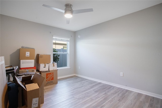 empty room with ceiling fan and light hardwood / wood-style flooring