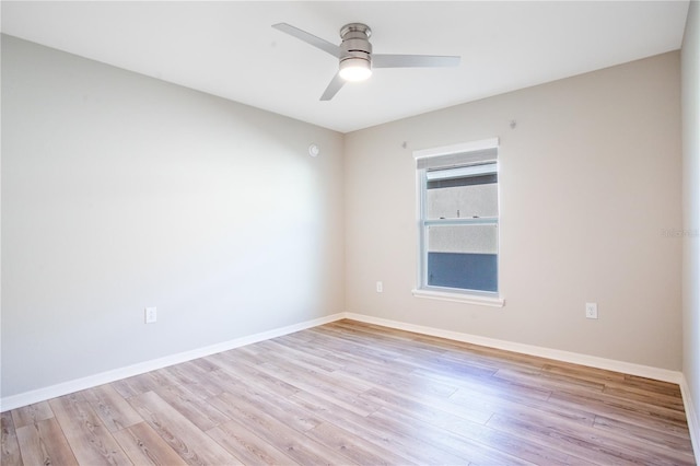 empty room with ceiling fan and light hardwood / wood-style flooring