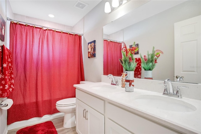 full bathroom with vanity, toilet, wood-type flooring, and shower / bath combo with shower curtain