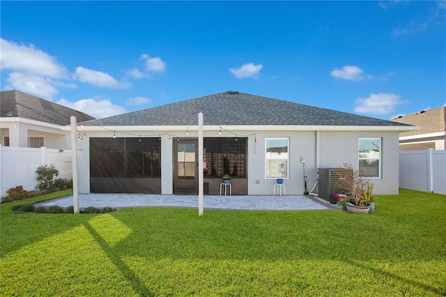 back of house featuring a yard, a patio, and central AC