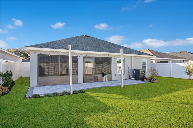 back of property featuring a lawn and central AC