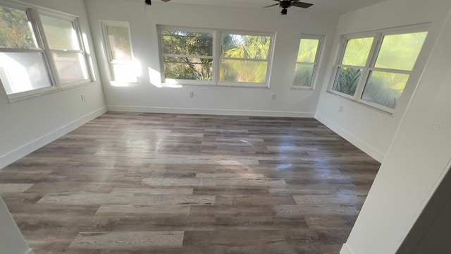 unfurnished sunroom featuring ceiling fan