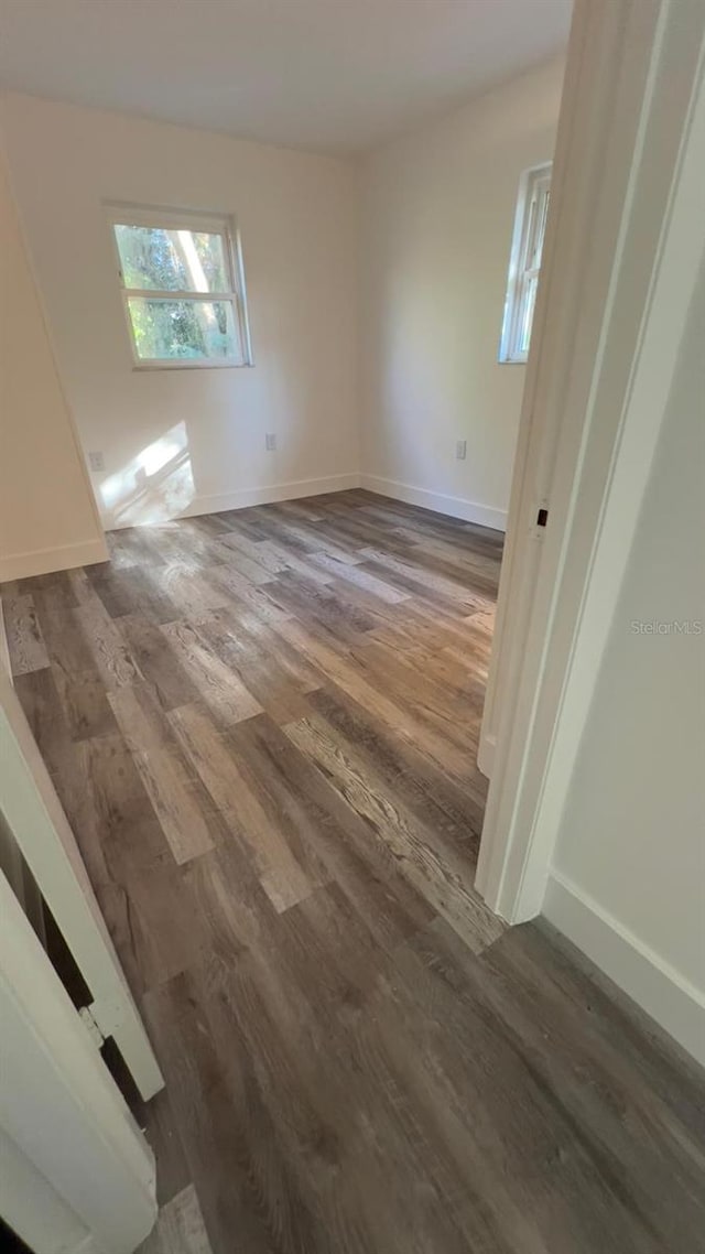 spare room with dark hardwood / wood-style floors