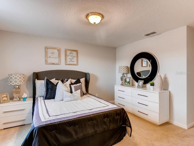 carpeted bedroom with a textured ceiling