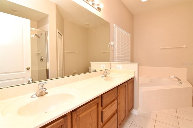 bathroom featuring tile patterned floors, vanity, and shower with separate bathtub