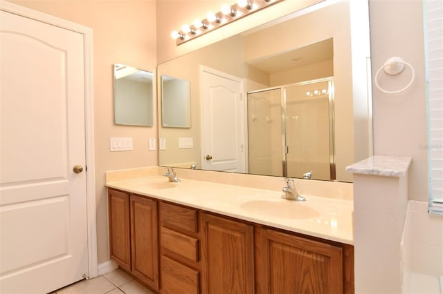 bathroom with tile patterned flooring, vanity, and an enclosed shower