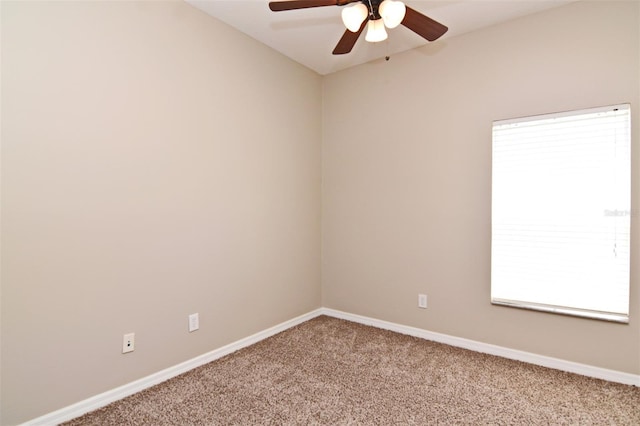 carpeted spare room with a wealth of natural light and ceiling fan