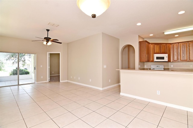 kitchen with ceiling fan, light tile patterned flooring, and white appliances