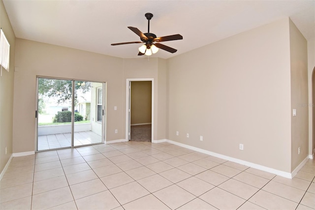 spare room with ceiling fan and light tile patterned flooring