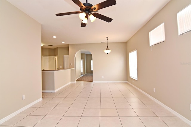 unfurnished room with ceiling fan and light tile patterned flooring