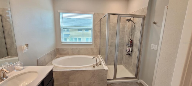 bathroom with vanity and independent shower and bath