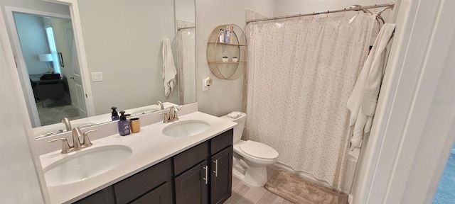 full bathroom featuring vanity, shower / bath combination with curtain, and toilet