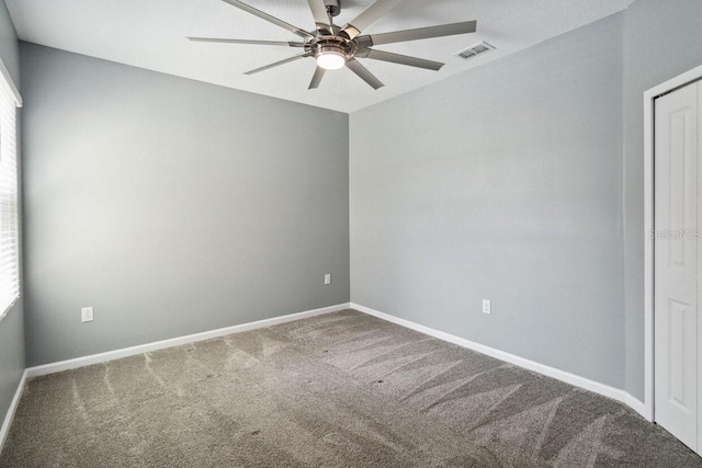 carpeted spare room with ceiling fan