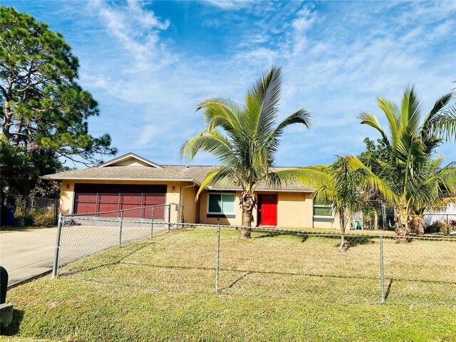 single story home featuring a garage and a front yard