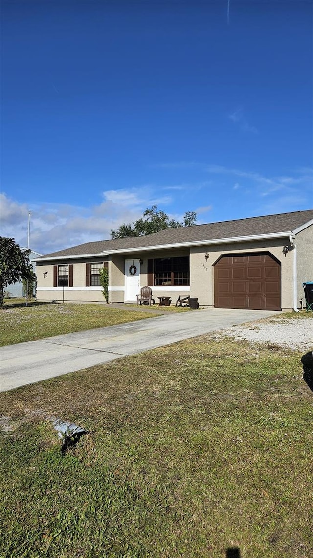 single story home with a front yard and a garage