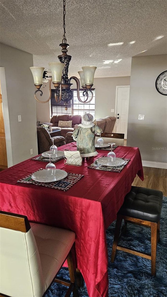 dining room featuring hardwood / wood-style floors and a textured ceiling