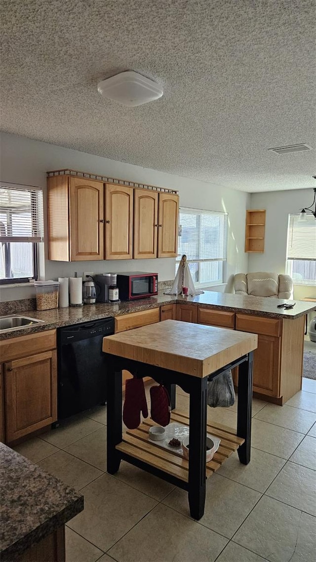 kitchen featuring sink, light tile patterned flooring, black appliances, and a textured ceiling