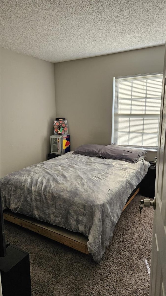 carpeted bedroom featuring a textured ceiling